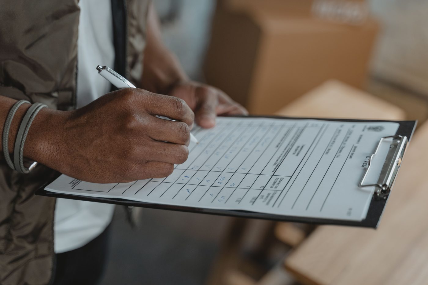 Someone completing a compliance checklist on a clipboard